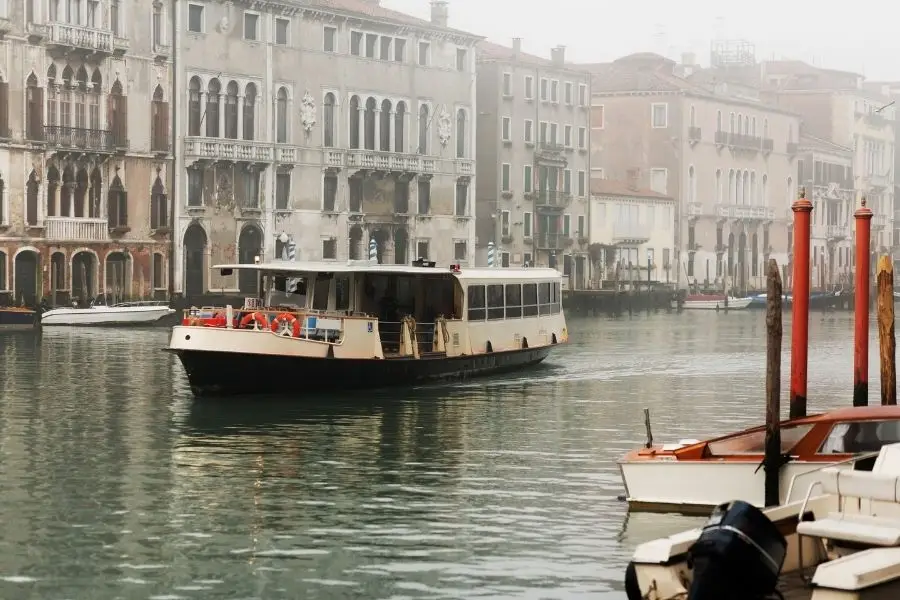 A vaporetto gliding along a misty Grand Canal past Venetian palazzos